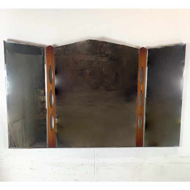 This vintage Mid-Century Modern tri-fold mirror captures the refined balance of sculpture and utility that defined...