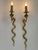 Set of two rare, elegant and highly decorative mid-century modern cast brass cobra sconces or wall lamps. Designed and...