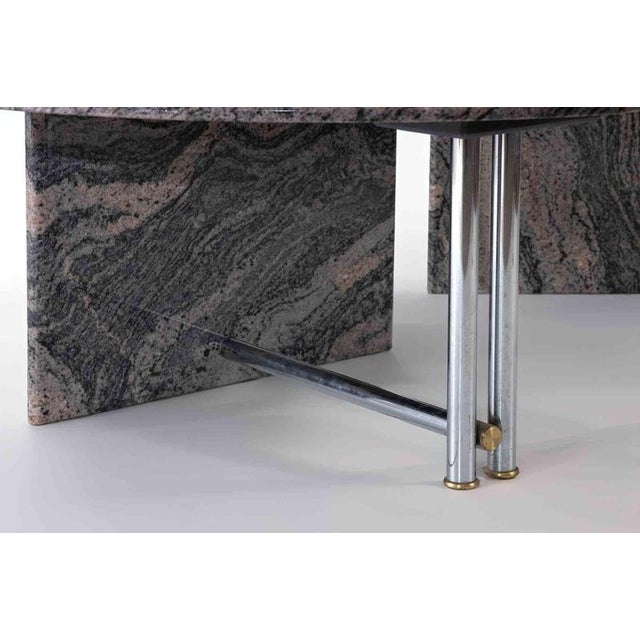 Pair of granite cofee tables with chromed steel structure, realized by an italian manufacture in 1980s. Sculptural and...