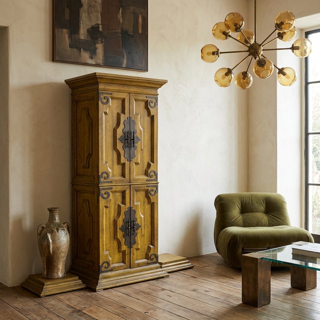 Spanish Mediterranean / Spanish Revival tall four-door cabinet, likely 1960s–1970s. Solid wood construction (oak or pine)...
