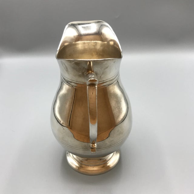 Beautiful silver plated water pitcher. Simple elegant design. Feels good in your hand.