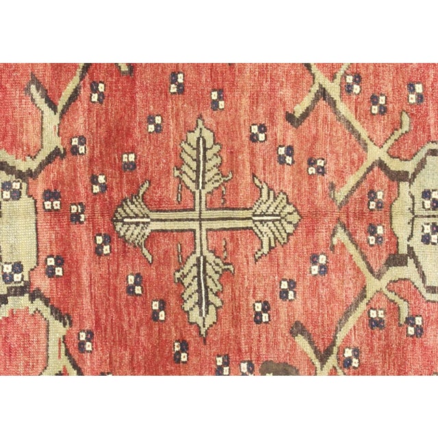 A vintage Turkish Oushak measuring 5'6" x 10'4", hand-woven with wool on wool foundation. This piece displays the region's...