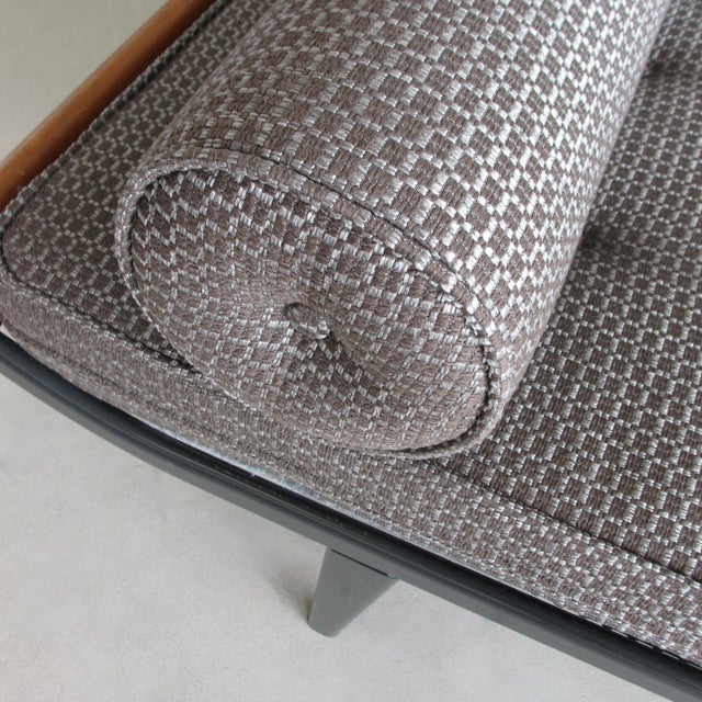 Black metal frame and slanted tapered legs with solid teak wooden end-pieces. Mattress with recently upholstered wool...