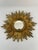 A gorgeous 13.5" French gilded resin Sunburst Wall Mirror, circa 1970s. Sourced from France. This splendid piece features...