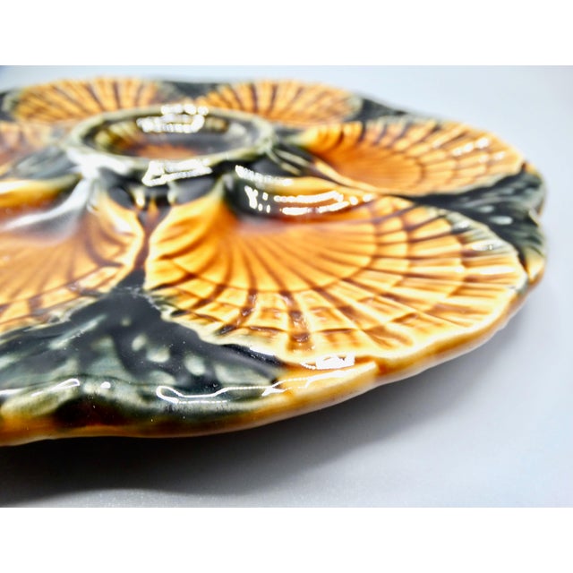 French Sarreguemines oyster plate in a lovely green and bronze / brown color with 6 wells for oysters and a central well...