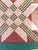 Pink and green pieces quilt panel framed behind glass. Black and gold frame with linen matting. Dimensions: 33 3/4" W x 33...
