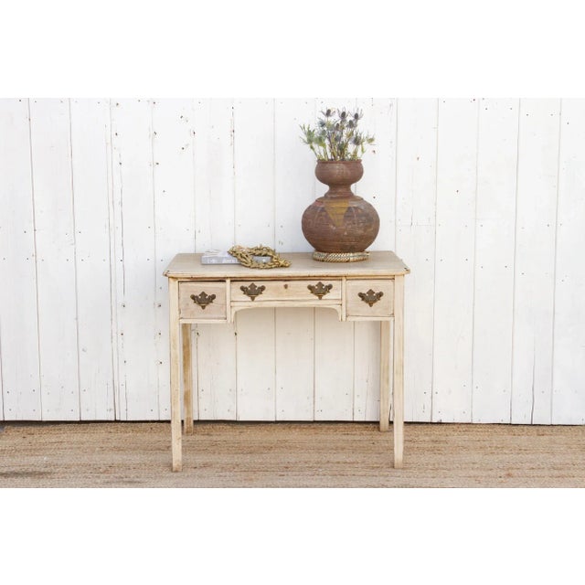 A beautiful English mahogany lowboy of Georgian style with corner aprons, tapered legs, its original hardware and three...