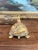 This Vintage Figurine depicts an intricately carved and painted Turtle. It is gold toned and engraved on the bottom. This...