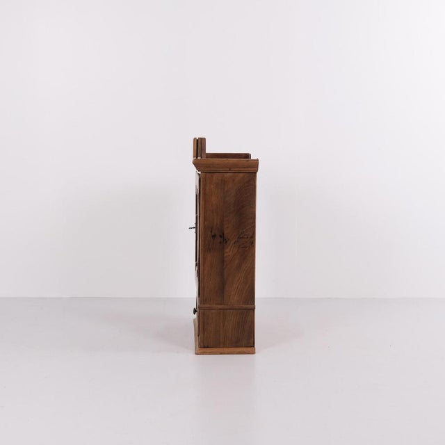 Wall cabinet also used as a tobacco cabinet made in oak from the 1930s. The cabinet has compact dimensions and is fitted...