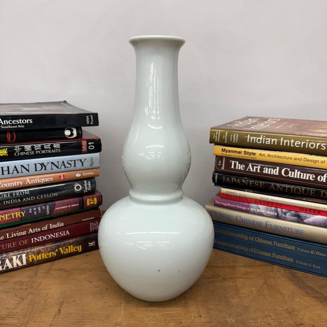 "About This Piece About This Piece A vision of subtlety and grace, this vase captures timeless elegance in its pure white...