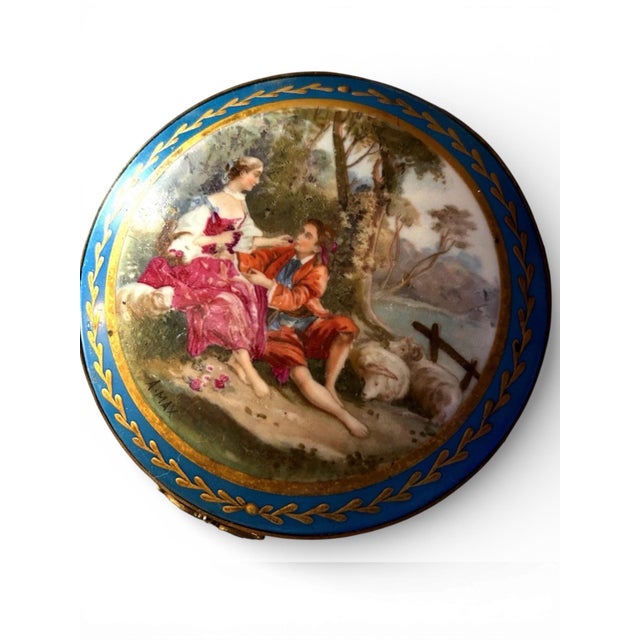 Sevres style gilded bronze jewelry box with hand painted porcelain lid. Has a reclining couple in a romantic setting. Very...