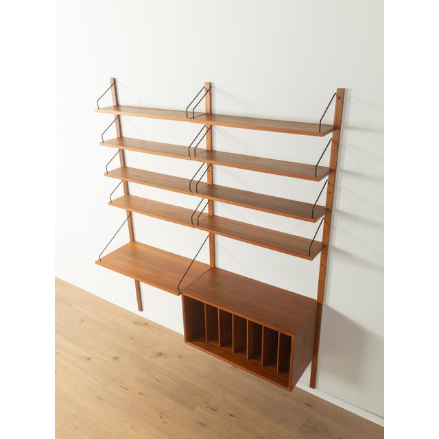 A classic shelving system from the 1960s. The high-quality containers and shelves are veneered in teak. The system...