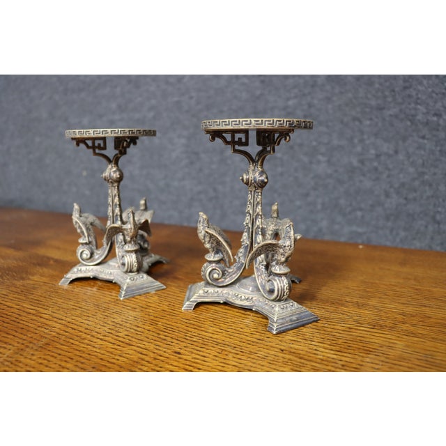 Exceptional pair of Victorian silver-plated centerpieces featuring stylized birds, scrolling foliage, and architectural...