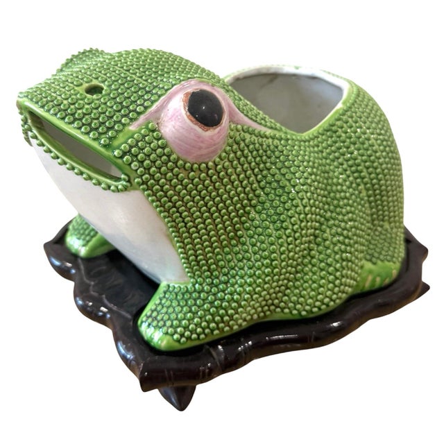 Chinese export frog jardiniere. Bright green body with pink eyes. Black carved lotus stand. Nice large size.