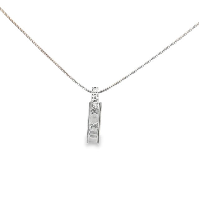 A vintage necklace by Tiffany & Co featuring their Atlas design. This pendant necklace is crafted with 18k gold. The bail...