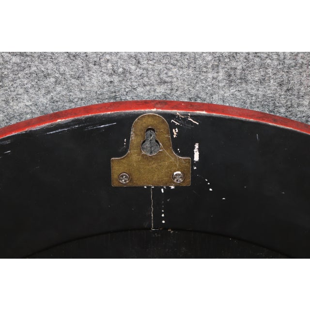 This exquisite early 1920s oval chinoiserie lacquered mirror is a striking decorative piece that beautifully captures the...