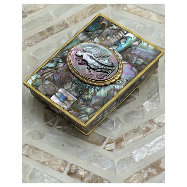 One of a kind Vintage Abalone shell box with a rare cameo of a winged warrior goddess. Box dates back to 1950s-60s. It is...