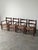 This vintage set of four fireside chairs is built from solid pine in a dark-toned stain, with a ladder-back frame, hand-...