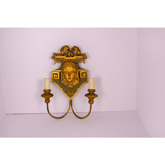 Neoclassical carved-wood sconce with a face of a woman and a bow. Celadon green with gilded accents, the piece has a very...
