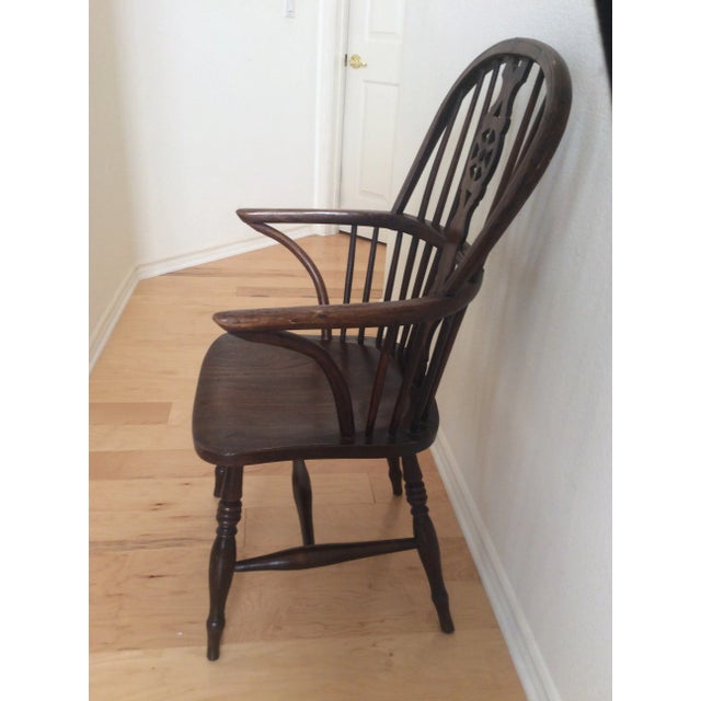 This Windsor Chair circa 1800s features a ship’s wheel design on the pierced back slat. The legs also feature ring...