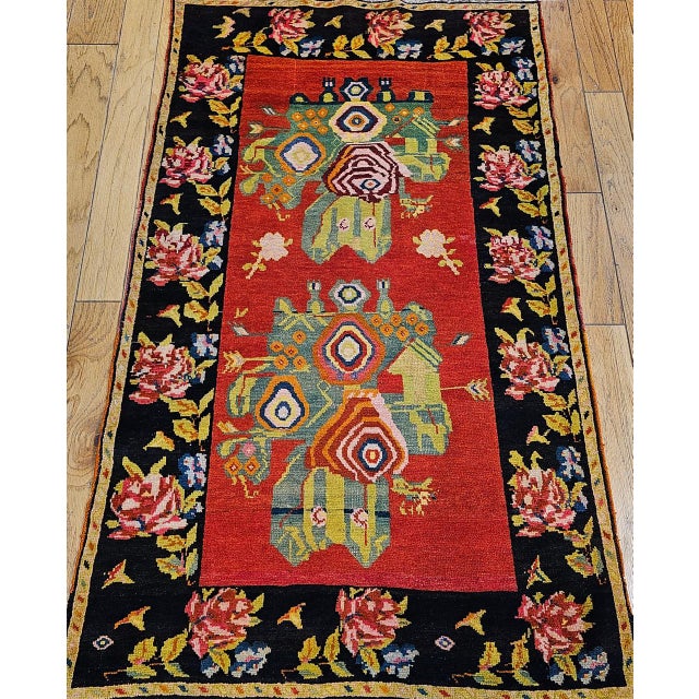 A vibrant and evocative vintage Karabagh rug from the Armenian village weavers of the Caucasus Mountains, this early 20th...