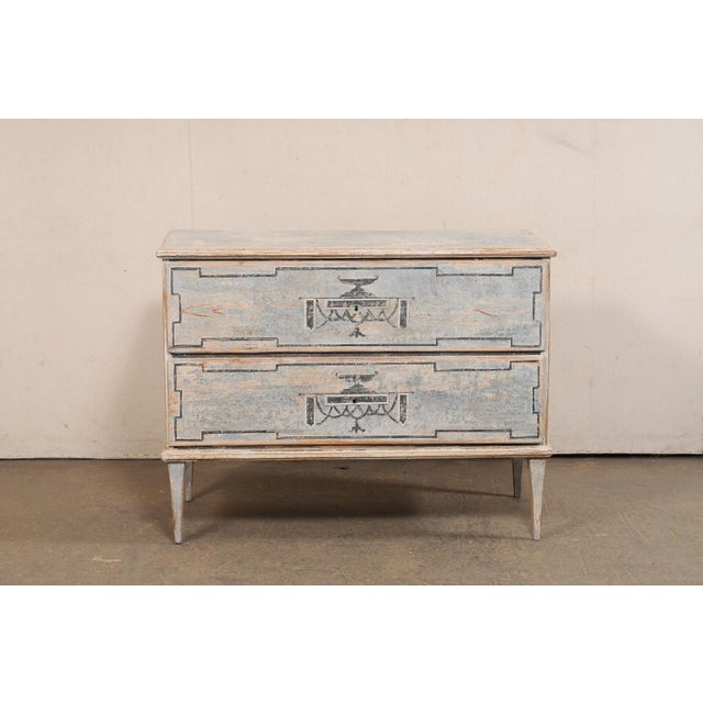 A hand-painted raised two-drawer French chest from the 19th century. This antique chest from France is decorated in a...