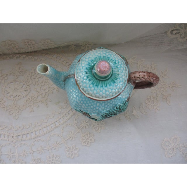 This is a Beautiful! Antique Majolica Teapot in a Robins Egg Blue with Brown Edging and Basket Weave Handle and a Pink...