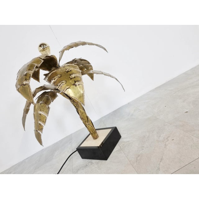 Beautiful torch cut brass palm tree table lamp by Maison Jansen. This palm lamp has a top mounted light point. Base is...