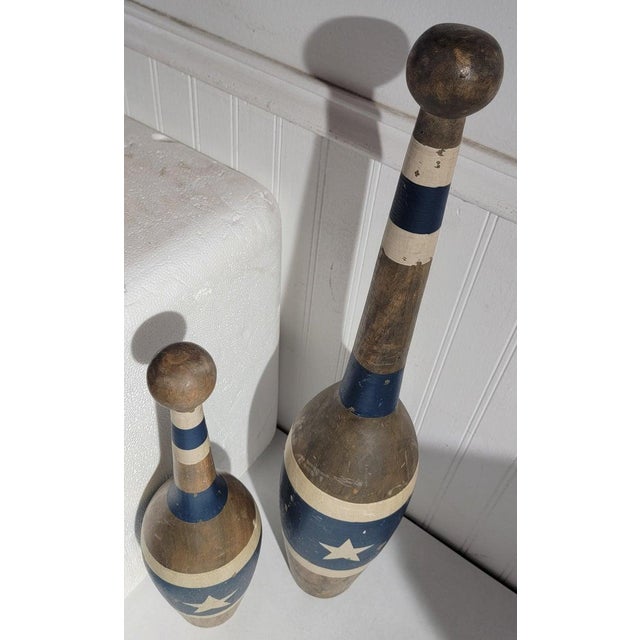 These amazing early 20thc original blue cream painted juggling pins are in amazing condition and two different sizes.One...