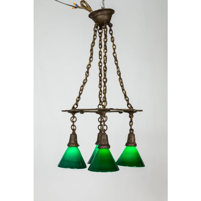 A classic, English Art & Crafts, hand forged and hammered, 4-light chandelier. With Tudor Revival undertones and perfectly...