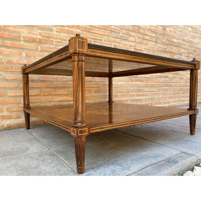 Mid-Century Modern two-tier side table or corner table with a square shape and four legs. The table has the entire base...