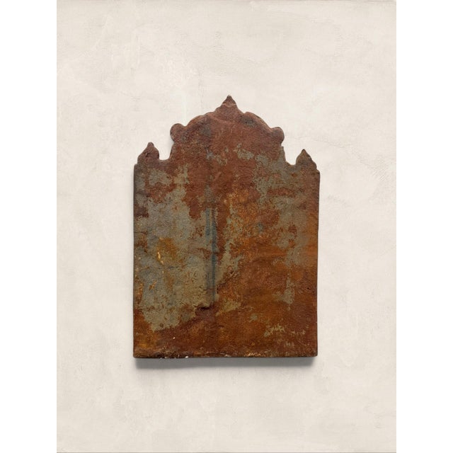 An antique cast iron fireback bearing the inscription “PAX,” the Latin word for peace, and the cast date 1679. The relief...