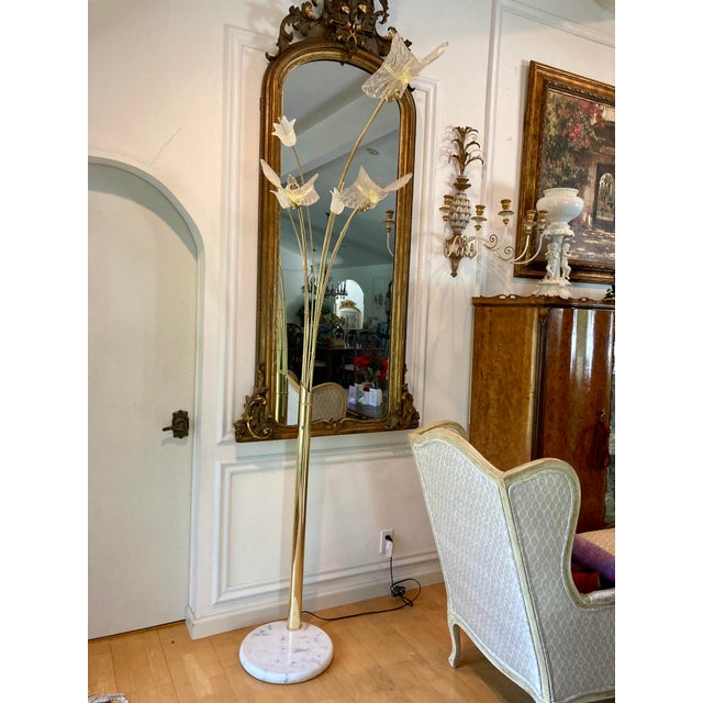Mid-century gilt brass floor lamp, Murano style ribbed glass shades with yellow accent ribbon. Three decorative white...