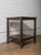 This solid wood side table features a simple, utilitarian form paired with rich surface character developed through age...