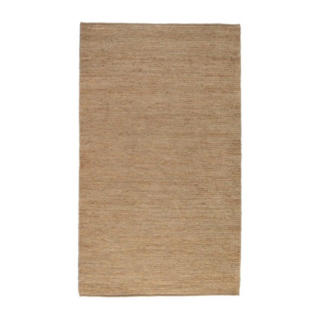 Handwoven jute rug with beautiful natural tones and organic textures. Sustainable material with lasting durability....
