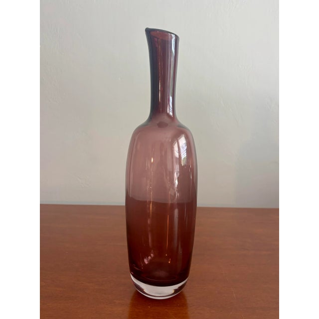 Exceptional mid century art glass vase. Attributed to Blenko. Classic bottle shape with a flared opening. Glass is thick...