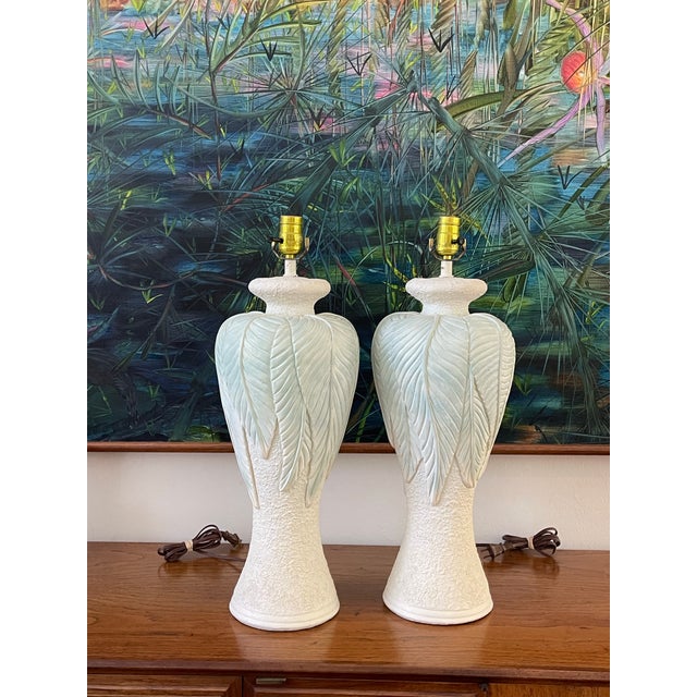 Pair of sculptural vintage table lamps featuring dramatic botanical leaf relief cascading over a textured tapered form....