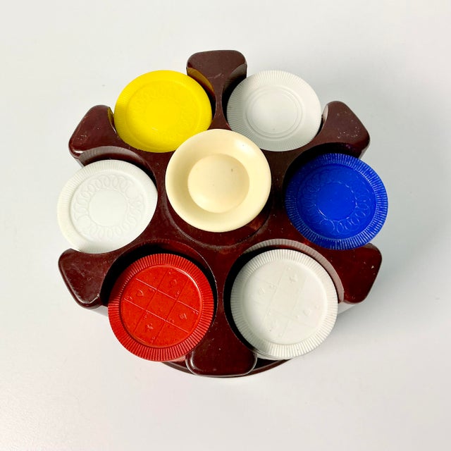 A vintage poker chip caddy with chips in four colors. There are approximately 24 chips in each of the six slots for just...