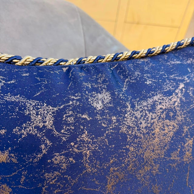 The handmade cover uses a deep navy ground with abstract gold metallic thread woven throughout, and the edge treatment is...