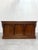 A stunning antique counter crafted in rich elm wood, featuring elegant carved details and a timeless paneled design. This...