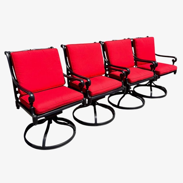 Set of four Frontgate Carlisle swivel dining armchairs in black powder-coated cast aluminum with lattice seats and...
