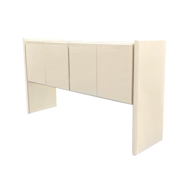 An ivory lacquer sideboard designed by Milo Baughman (1923-2003) for Thayer Coggin. This sideboard features two double...