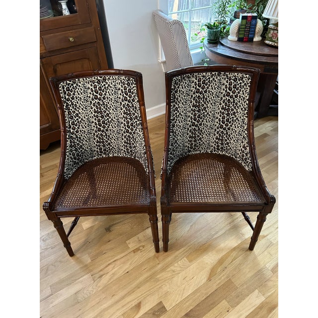 These vintage Faux Bamboo regency chairs have it all… faux bamboo mahogany frames, caned seats, chenille leopard or...