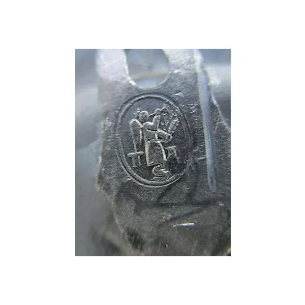 English pewter wall plate featuring an embossed crest flanked by lions with the Roman motto "In Fide Constans" (Always...