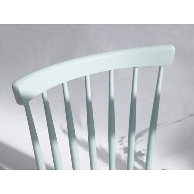 Wooden mid century swindle chair painted in baby blue and made in Czechoslovakia. The seat of the chair is a little lower...