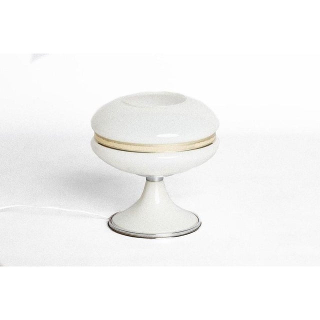 This vintage Space Age lamp is a beautiful decorative object realized in Italy during the 1970s. An elegant table lamp...