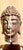 This item is an extra large, ceramic Buddha head sculpture mounted on a metal stand. It is a decorative piece inspired by...
