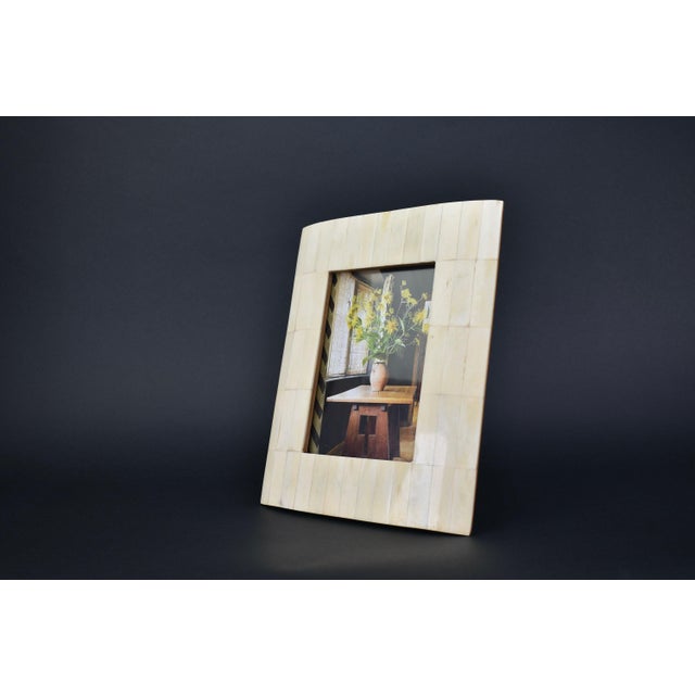 Beautiful and timeless picture frame. The frame is made from bone rectangles on a solid teak wood. The frame comes with a...