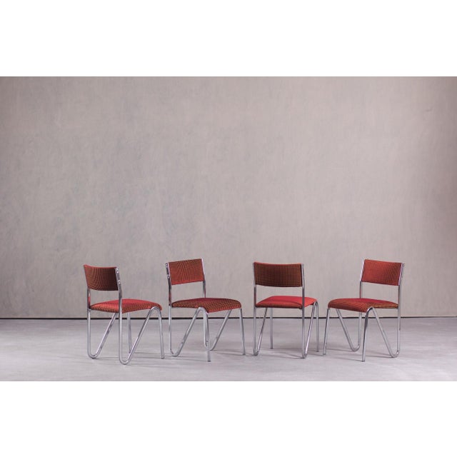 This set of four vintage stacking chairs was made in Germany during the 1980s. The chairs feature a chrome-plated tubular...