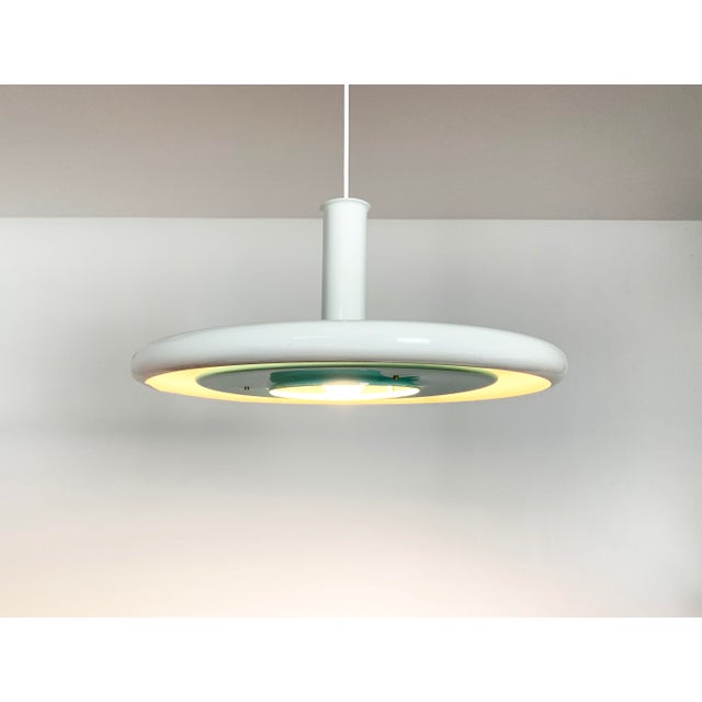 1970s Danish Ufo style Pendant lamp, model "Optima". Design by Hans Due for Fog & Morup in 1972. Incredible thin from the...